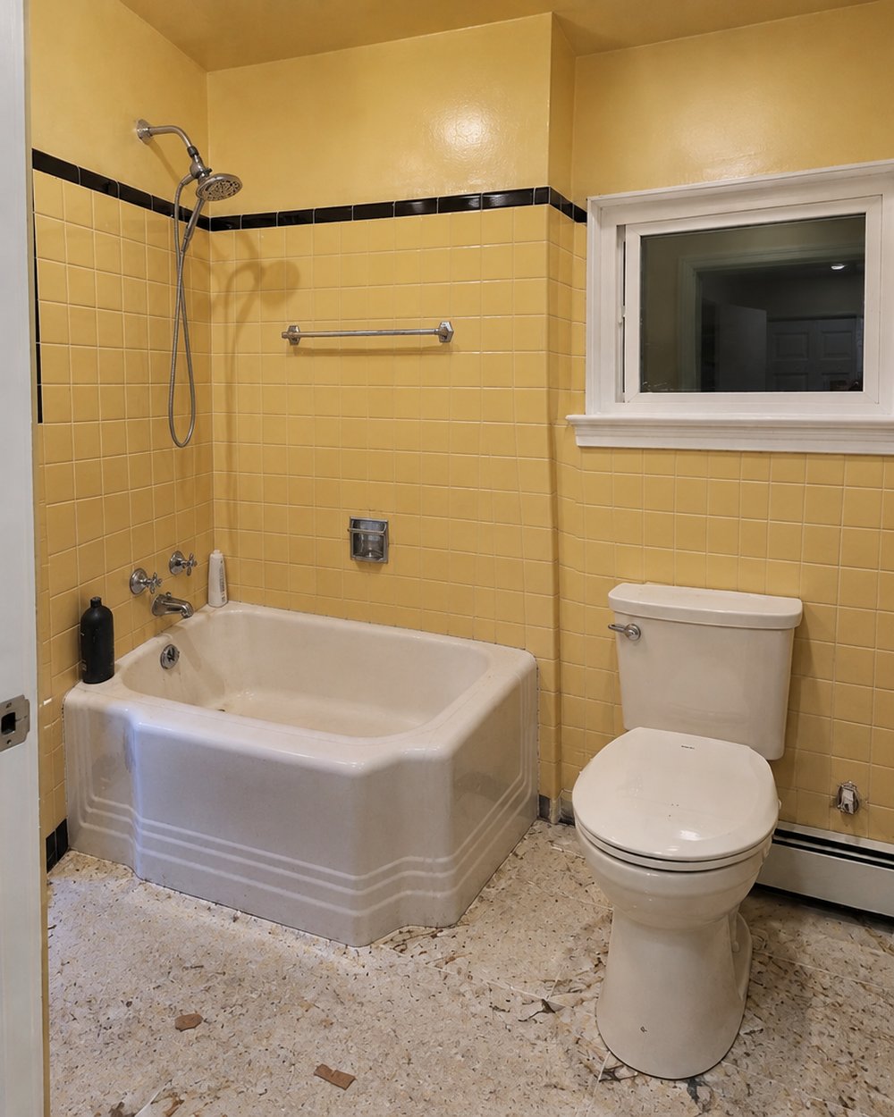 Before: Original 1960s yellow tile and a cast tub